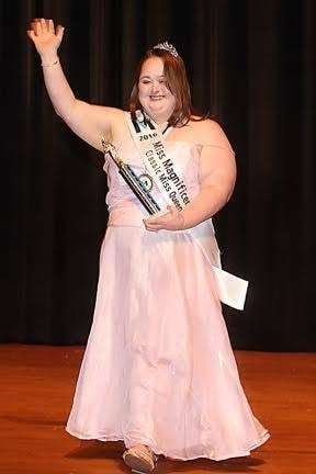 Joyful participant being crowned at the pageant